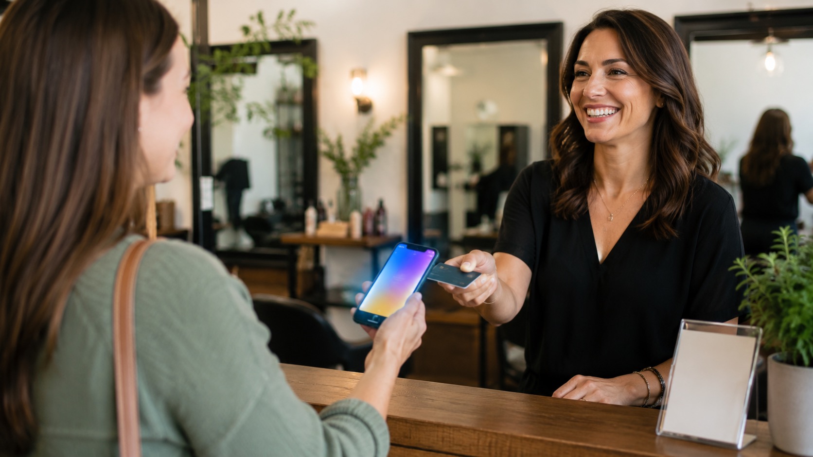 A customer tapping their smartphone on a TapForge NFC card at a local business counter to leave a Google review